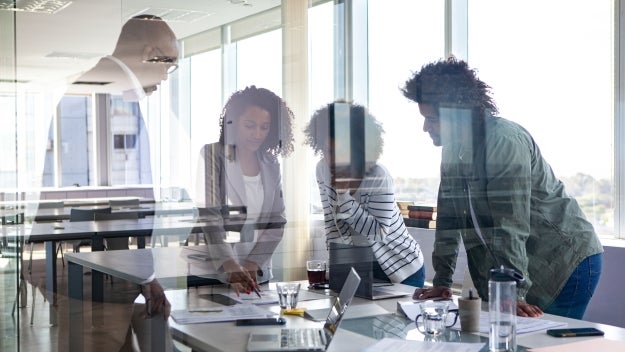 people gathered around a workspace